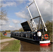 Canal Boat cruising towards a lock.